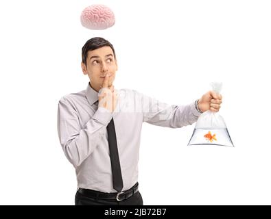 Young clever man with brain above his head holding a goldfish in a plastic bag isolated on white background Stock Photo