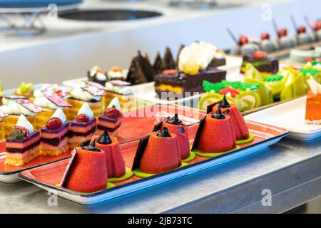 Beautiful and bright photo of pastries and cakes on the bar counter in the hotel Stock Photo