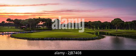 Golf course panorama at sunset with beautiful sky Stock Photo