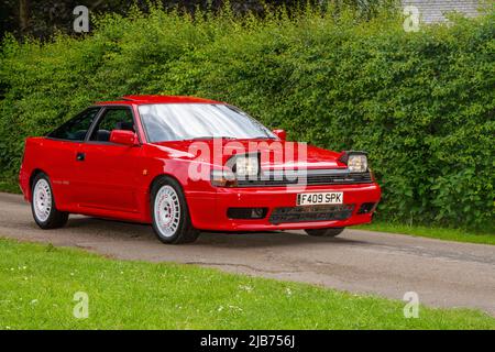 1989 80s eighties TOYOTA four-wheel drive, 1998 cc petrol sports coupe with flip up Headlights, arriving in Worden Park Motor Village for the Leyland Festival, UK Stock Photo