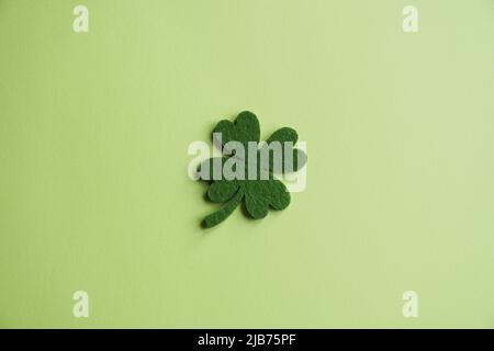 four-leaf clover made from felt on green background Stock Photo