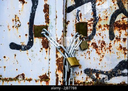 Rusty lock on the gate of a small gray container close-up. High quality photo Stock Photo