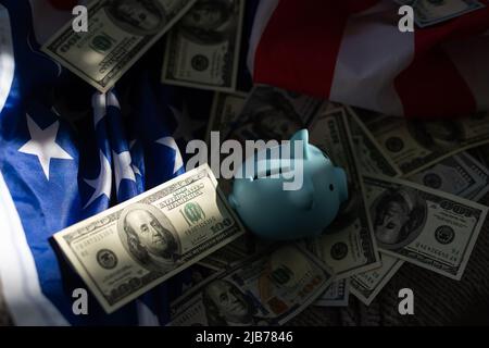 piggy bank with paper currency on an American Flag