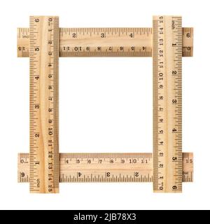 Empty square picture frame, made of four wooden rulers, isolated on white background Stock Photo