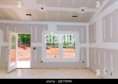 Finishing plastering drywall in ready for paint with new house Stock Photo