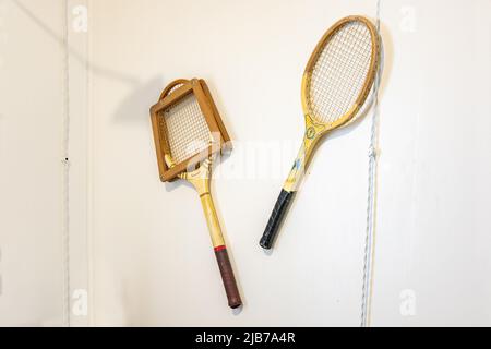 Punta Umbria, Huelva, Spain - April 27, 2022: Two old tennis rackets hanging on a wall Inside of a english summer house in Punta Umbria, build in the Stock Photo