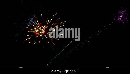 Image of colourful christmas and new year fireworks exploding in night sky Stock Photo