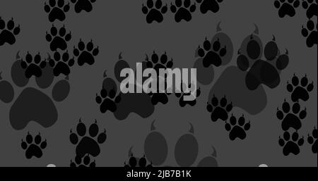 Image of black dog paw prints filling dark grey background Stock Photo
