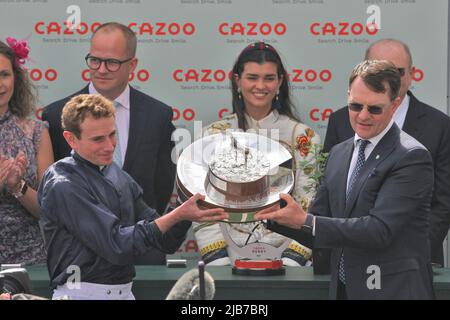 Epsom Downs, Surrey, UK. 3rd June, 2022. The Coolmore connections and Ryan Moore with Aidan O'Brien lift the trophy after winning a photo finish at the Cazoo Oaks Classic horse race Credit: Motofoto/Alamy Live News Stock Photo