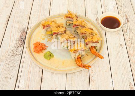 Uramaki dragon roll sushi with king prawns, Japanese rice, red tuna with dried tuna slices, ginger, wasabi and soy sauce Stock Photo