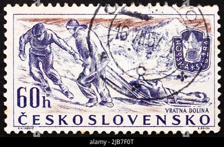 CZECHOSLOVAKIA - CIRCA 1957: a stamp printed in the Czechoslovakia shows Rescue Team, Mountain Climbing Rescue Service, circa 1957 Stock Photo