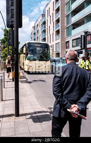 Epson Surrey, London UK, June 03 2022, People Crossing Road Infront Of A Public Transport Coach Stock Photo