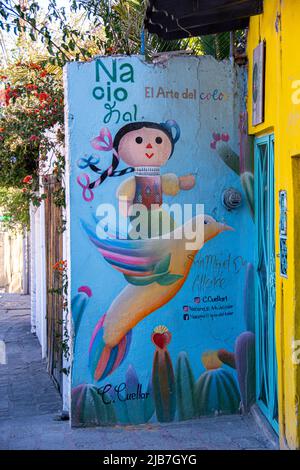 A painted mural on the wall of a building featuring a little girl flying on a bird, Guanajuato, Mexico. Stock Photo