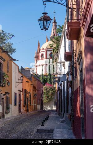The downtown area of San Miguel de Allende, Mexico. Further up the cobble stone street leads to the city's main plaza. Stock Photo