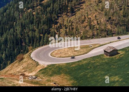 Motorcycle driver riding in Alpine highway, Nockalmstrasse, Austria, Europe. Stock Photo