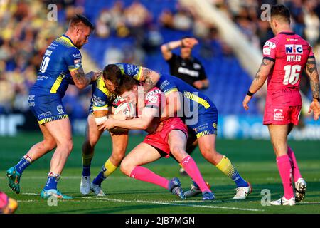 Leeds Rhinos' Morgan Gannon is tackled by Wigan Warriors' Sam Walters ...