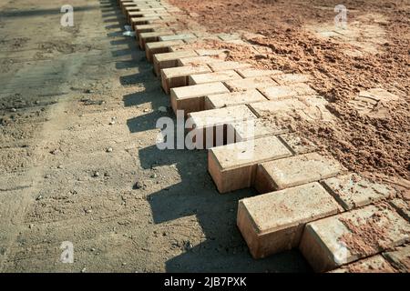 not fully laid paving slabs on the site prepared for laying Stock Photo