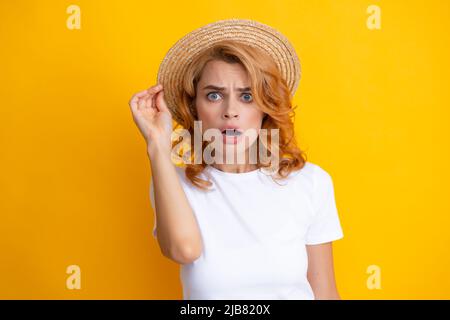 Excited amazed woman in straw hat isolated on yellow studio background. Stock Photo