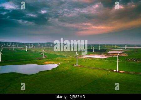 Renewable energy concept, windmills at sunset Stock Photo - Alamy