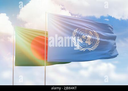 United Nations and Bangladesh flags waving together in the wind on blue ...