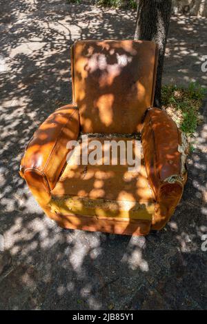 Old leather armchair at Vide Grenier, Car Boot sale in France Stock Photo