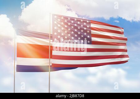 Sunny blue sky and flags of united states of america and costa rica Stock Photo