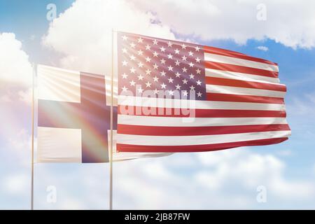 Sunny blue sky and flags of united states of america and finland Stock Photo