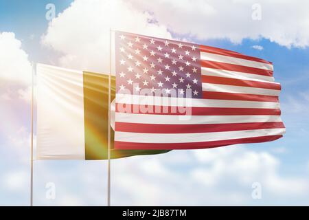 Sunny blue sky and flags of united states of america and pakistan Stock Photo