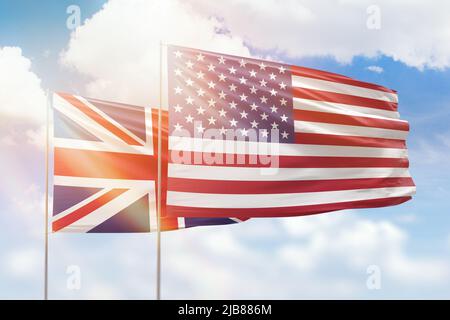 Sunny blue sky and flags of united states of america and united kingdom Stock Photo