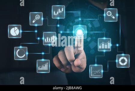 Man touching stock market virtual icons. Business man using Big data for analytics and business intelligence (BI) with chart and graph icons on a digi Stock Photo