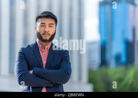 Asian man in a suit facing the camera Stock Photo