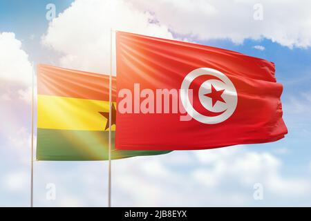 Ghana And Tunisia Flags Waving Together On Blue Cloudy Sky Two Country ghana-and-tunisia-flags-waving-together-on-blue-cloudy-sky-two-country