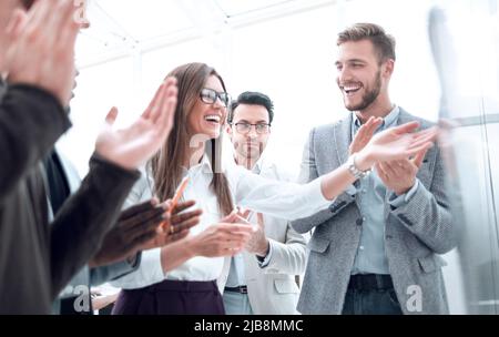 Multi-ethnic business team applauding to speaker after presentation on new project Stock Photo