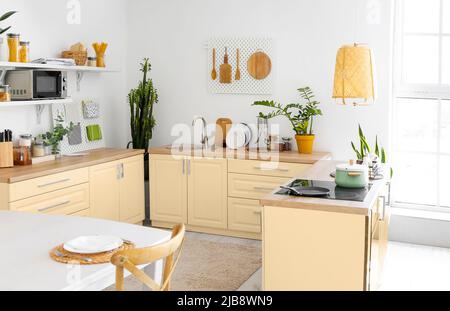 Light kitchen with modern furniture and pegboards Stock Photo