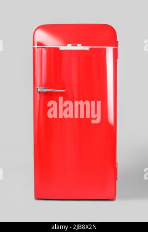 Stylish retro fridge on light background Stock Photo