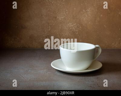 white empty coffee cup on restaurant table Stock Photo