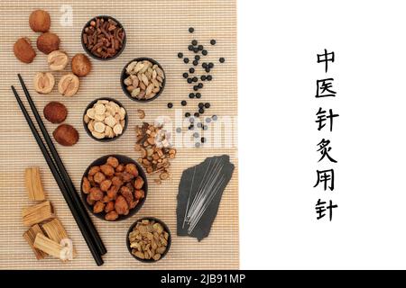 Chinese acupuncture needles with herbs, spice, pills to boost chi levels. Reads as Acupuncture needles used in traditional Chinese herbal medicine. Stock Photo