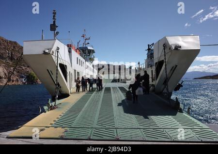 Chile Chico, Chile - March, 2020: People leaving car ferry down ladder. Car ferry moored at shore of lago General Carrera lake in Chilean Patagonia Stock Photo