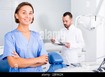 doctor with assistant are posing on workplace in hospital Stock Photo