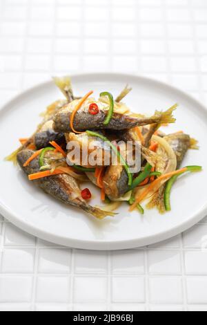 small fish escabeche ( deep fried horse mackerel marinated in spicy vinegar sauce ) Stock Photo