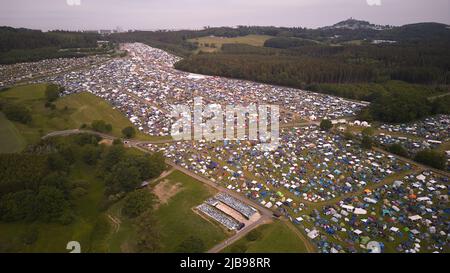 Nurburg, Germany. 04th June, 2022. 04 June 2022, Rhineland-Palatinate, Nürburg: Many festival-goers of the open-air rock festival 'Rock am Ring' camp out on huge camping areas around the Eifel race track (aerial view with a drone). The festival is sold out with 90,000 visitors. Photo: Thomas Frey/dpa Credit: dpa picture alliance/Alamy Live News Stock Photo