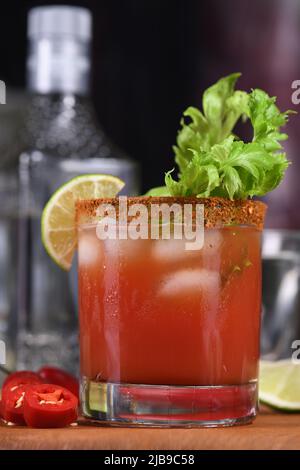 Michelada the Mexican Bloody Mary. Made with tequila, spicy sauce, served over ice in a glass of celery with a peppery rim, garnished with a stalk of Stock Photo