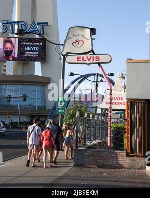 Las Vegas, United States. 03rd June, 2022. Pedestrians walk by the Little Chapel of Hearts which advertises 'Elvis Weddings' on their awning. Authentic Brands Group, which owns Elvis Presley's intellectual property rights, has sent several Las Vegas wedding chapels cease-and-desist letters requesting them to stop using Elvis Presley's image and likeness in their operations. (Photo by Gabe Ginsberg/SOPA Images/Sipa USA) Credit: Sipa USA/Alamy Live News Stock Photo