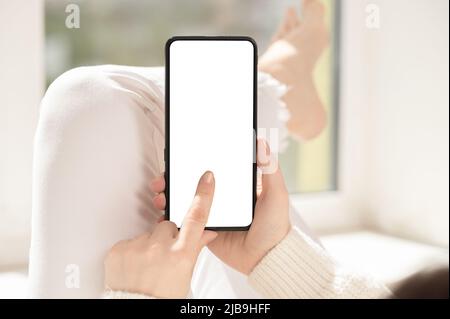 Cellphone mockup. woman finger presses on cell phone screen. Use mobile shopping app, check social media news, texting mobile sms order food delivery Stock Photo