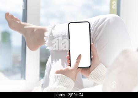 Cellphone mockup. woman finger presses on cell phone screen. Use mobile shopping app, check social media news, texting mobile sms order food delivery Stock Photo