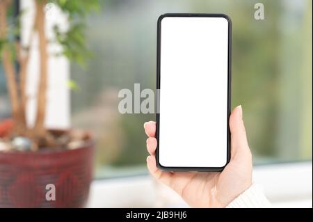 Mockup cellphone. Cropped shot view of woman hands holding smart phone with blank copy space screen for text message or information content. female re Stock Photo