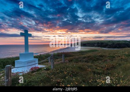 A landscape of the Anson Memorial overlooking Loe Bar in Cornwall at Sunset. In the distance Porthleven can just be glimpsed. Stock Photo