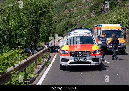 Polich, Germany. 04th June, 2022. 04 June 2022, Rhineland-Palatinate, Pölich: A sports car is trapped after an accident under a guardrail on the B53 federal highway between Mehring and Pölich. One person was slightly injured in the accident, a 53-year-old from Trier died. The driver of the accident is on the run, according to the Trier police department. The police are looking for witnesses. Photo: Harald Tittel/dpa Credit: dpa picture alliance/Alamy Live News Stock Photo