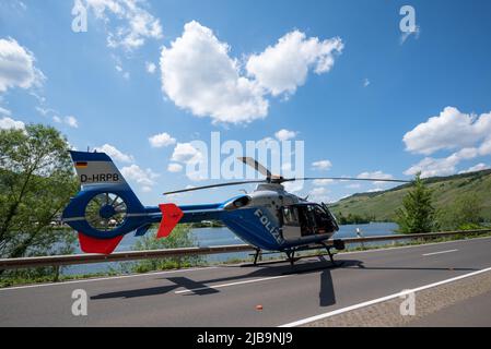 Polich, Germany. 04th June, 2022. 04 June 2022, Rhineland-Palatinate, Pölich: A police helicopter is close to the scene of the accident where a sports car was trapped under a guardrail on the B53 federal highway after an accident. One person was slightly injured in the accident, and a 53-year-old man from Trier died. The driver of the accident is a fugitive, according to the Trier police inspection. The police are looking for witnesses. Photo: Harald Tittel/dpa Credit: dpa picture alliance/Alamy Live News Stock Photo