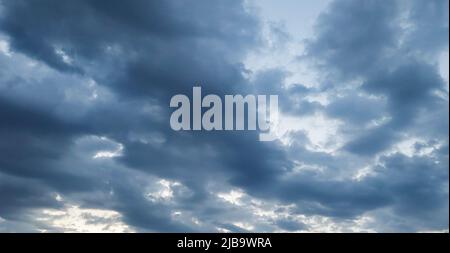 Landscape overlooking the sky covered with gray ragged clouds Stock Photo
